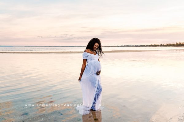 Radiant expectant mother joyfully showcasing her baby bump during a maternity photography session in Melbourne with Something Meaningful.