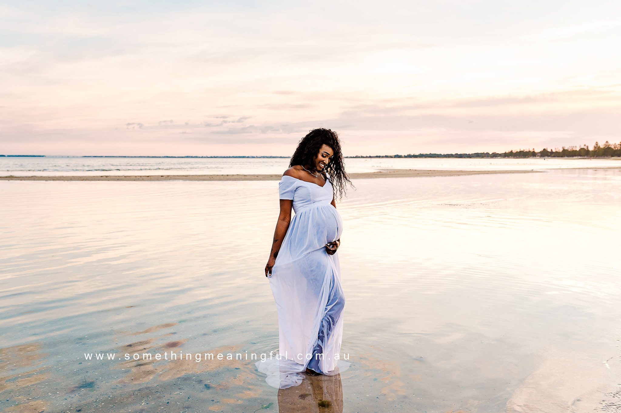 Radiant expectant mother joyfully showcasing her baby bump during a Maternity Photography Melbourne West with Something Meaningful.